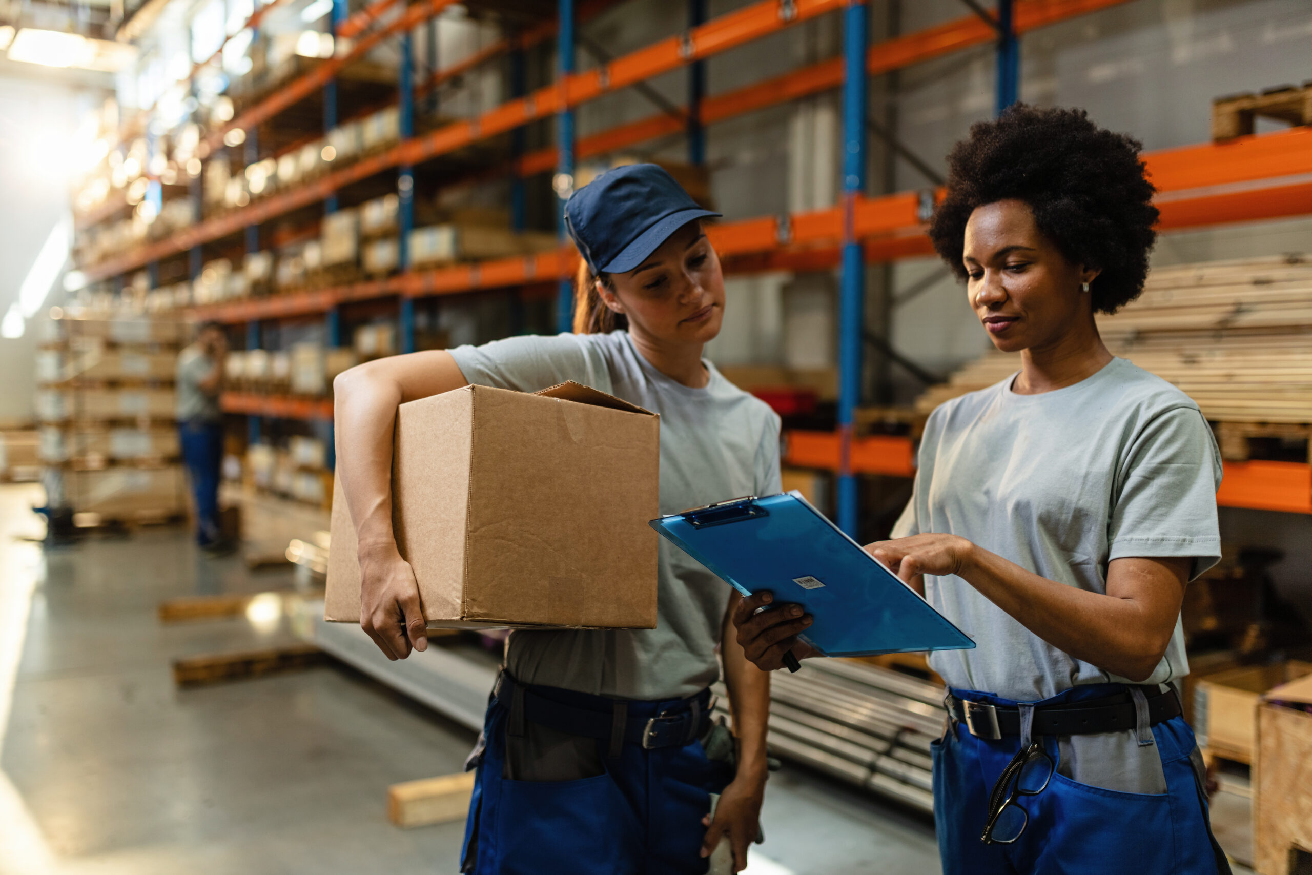 Warehouse team reviewing procurement paperwork and shipment readiness